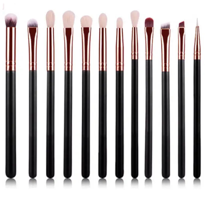 Professional makeup brushes with black handles and rose gold ferrules arranged in a row, showcasing various sizes for different makeup applications.
2.png