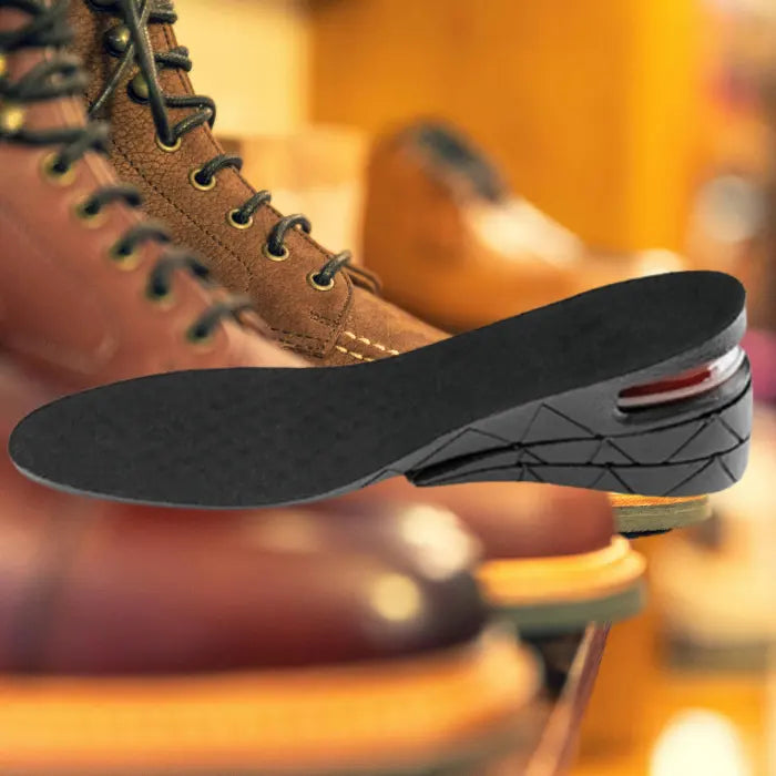 Adjustable height insoles showcased near rugged leather boots on display shelf in a boot store.