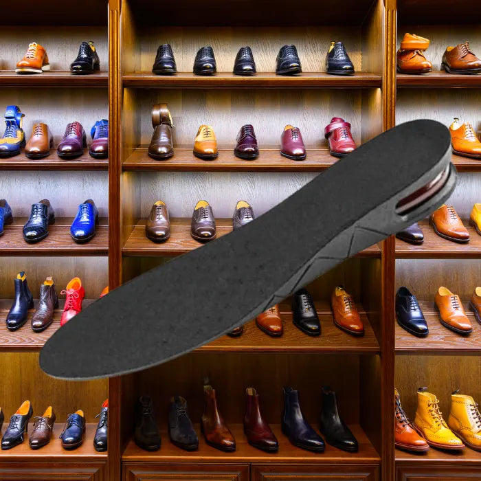 Adjustable height insoles placed in front of a wooden rack full of colorful formal dress shoes.