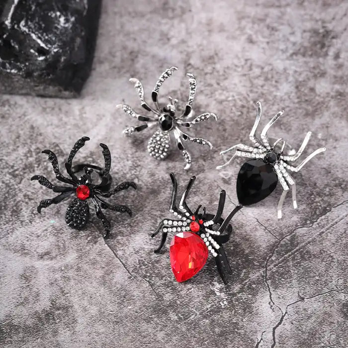 Blackwidow Spider rings set featuring various gemstone designs including red and black crystals