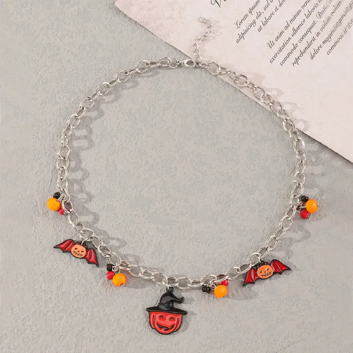 Front view of Halloween costume jewelry necklace with festive bat and pumpkin charms.