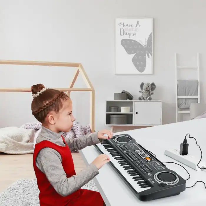 Electronic keyboard in a girl's bedroom showing her playing while connected to a power outlet.