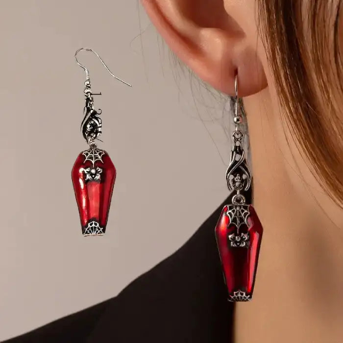 Halloween Blood Coffin Earrings worn on ear, showing bold red coffin shape and silver gothic details
