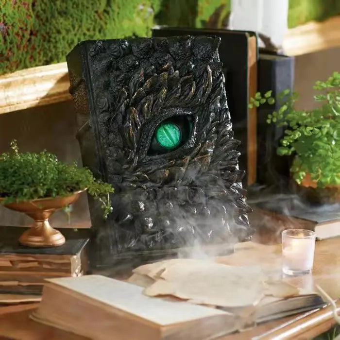 Halloween Decor book of dragons displayed among herbs, candles, and old scrolls on enchanted table.
