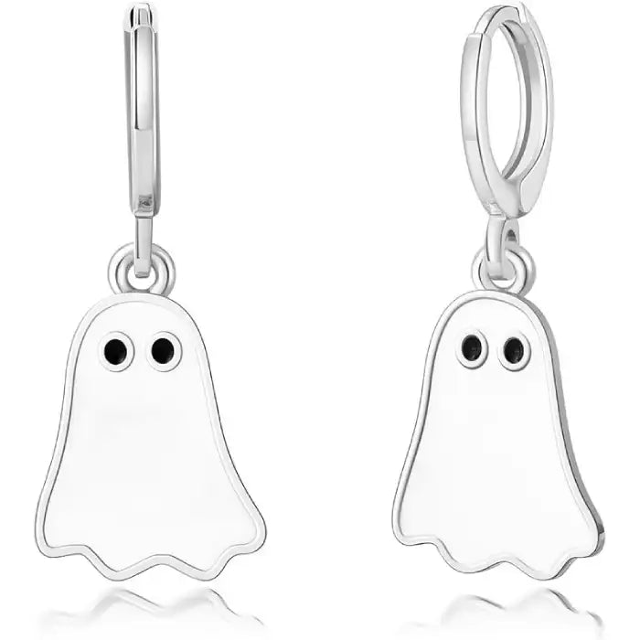 Close-up of Halloween earrings with silver ghost charms, black eyes, and smooth metal outline.