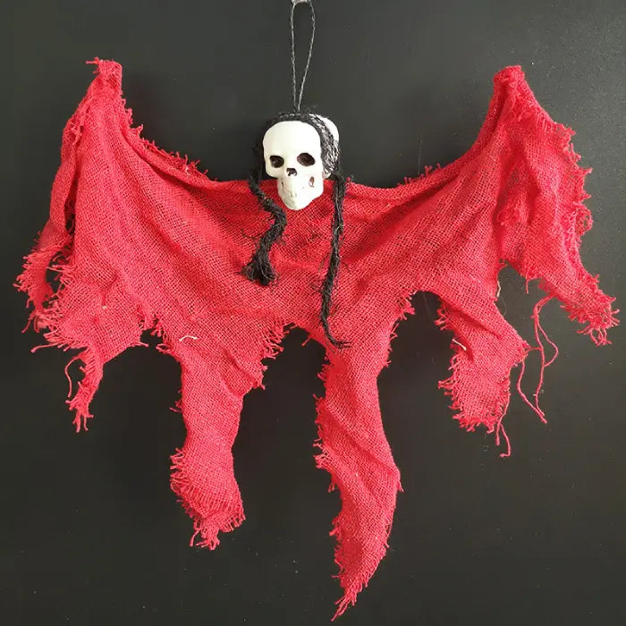 Halloween Ghost Skull figure with bright red shredded cloth and black braided hair.