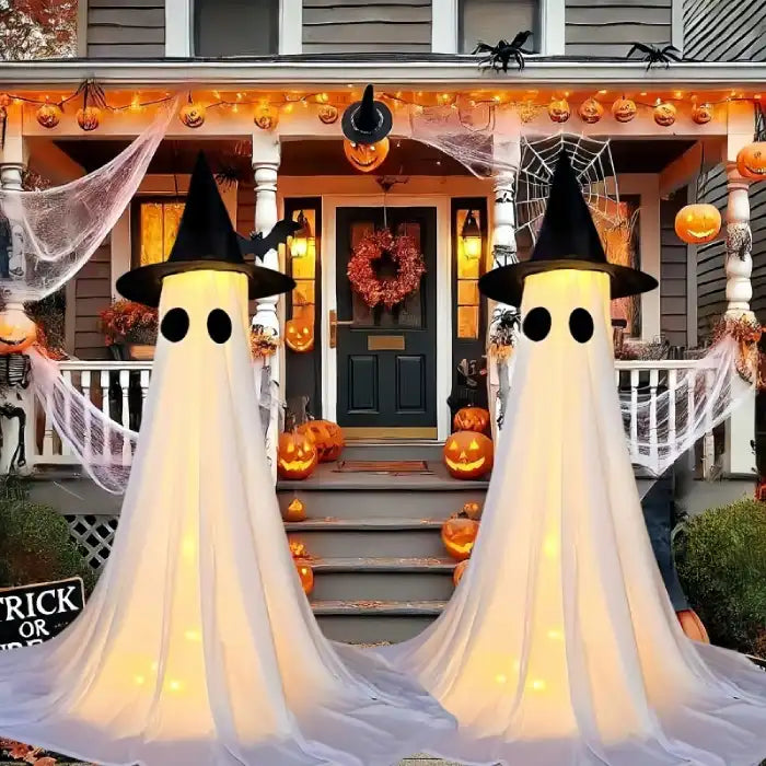 Halloween Ghost Yard Decor with witch hats on a decorated porch with pumpkins and spiderwebs.