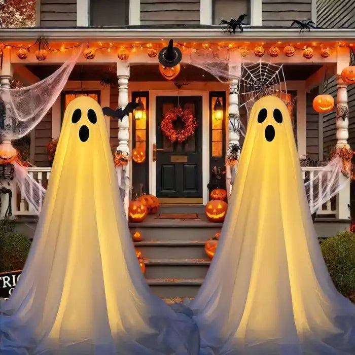Halloween Ghost Yard Decor glowing ghost pair on porch with pumpkins and festive Halloween lights.