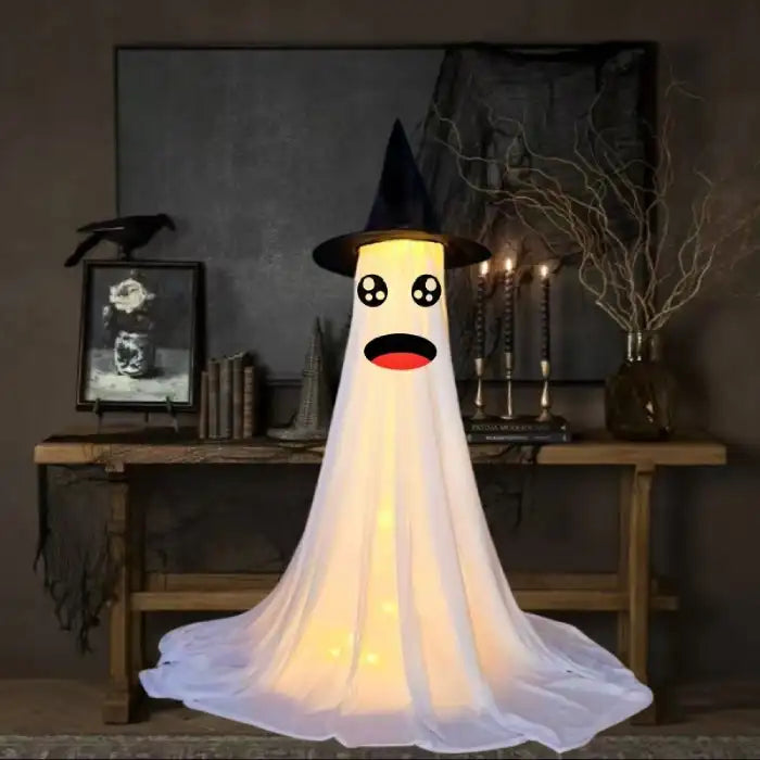 Halloween Ghost Yard Decor ghost with surprised anime-style eyes and witch hat in spooky indoor decor.