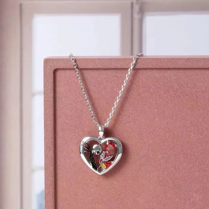 Halloween Gothic necklace with heart pendant displayed on pink box near window background