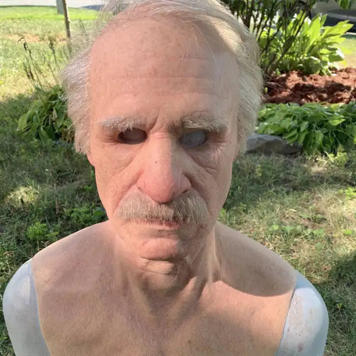 Halloween Mask of older man with mustache and bald top shown outdoors with realistic aging detail