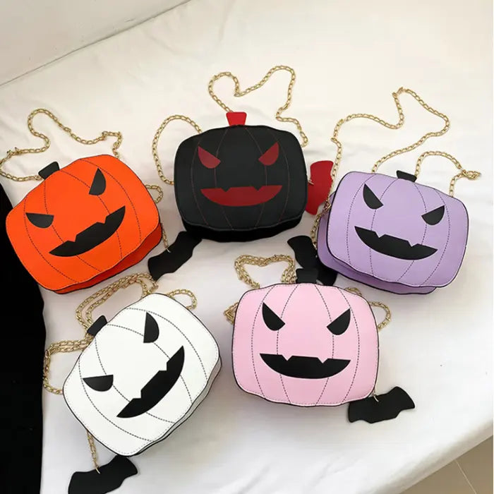 Halloween Pumpkin Head bag in orange, black, white, pink, and purple with gold chain strap