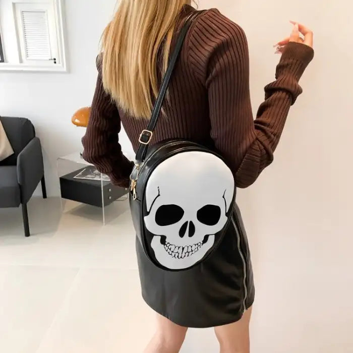 Halloween Skull Bag in black worn crossbody style with large white skull face detail.