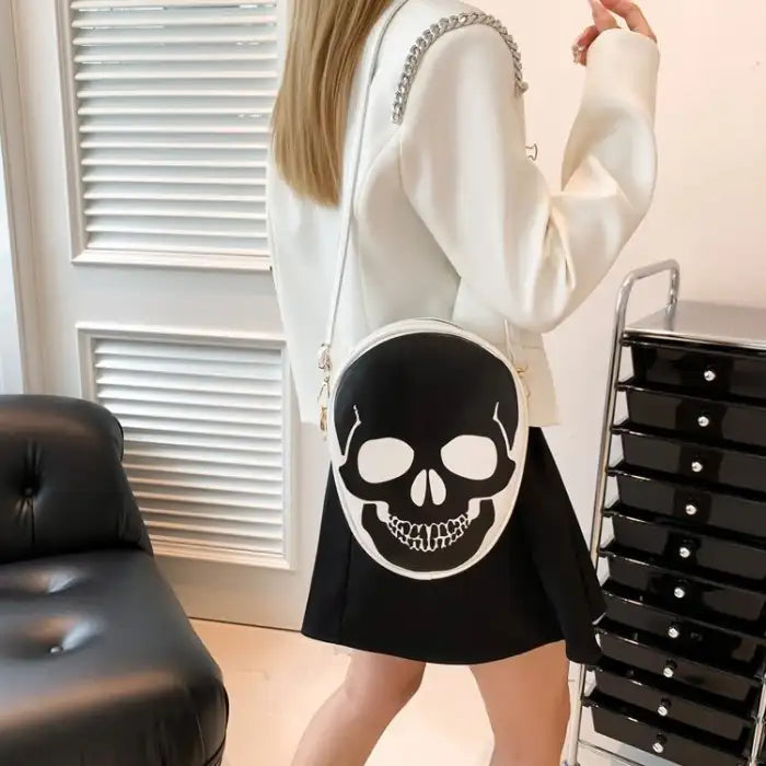 Halloween Skull Bag styled on model, white crossbody design with bold black skull print.