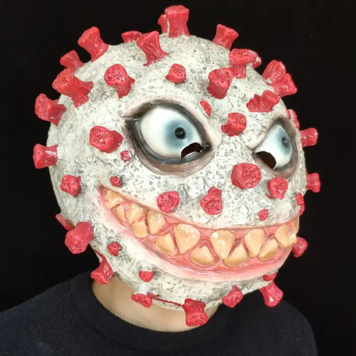 Halloween virus costume mask worn in profile, featuring menacing eyes, toothy smile, and red protrusions.