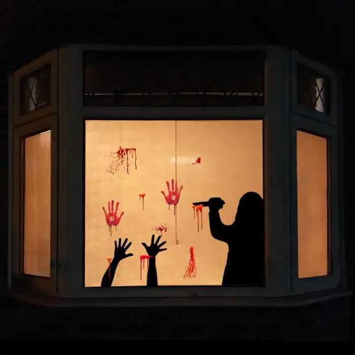 Halloween window decal featuring silhouette killer, raised hands, blood splatter, and handprints.