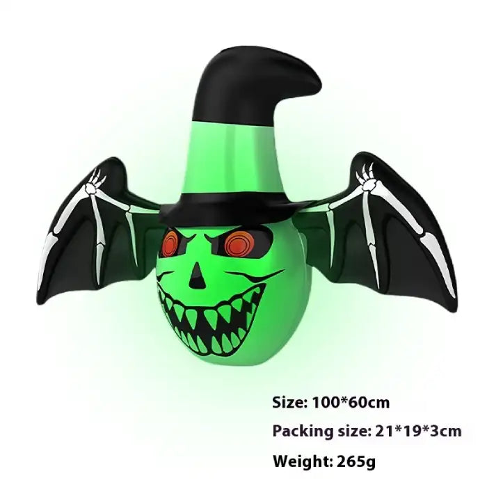 Halloween yard inflatables green witch face with bat wings and hat, perfect for night-time displays.