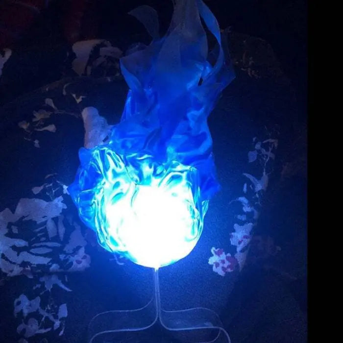 Handheld fireball prop with intense blue LED light, displayed on stand in low-light room.