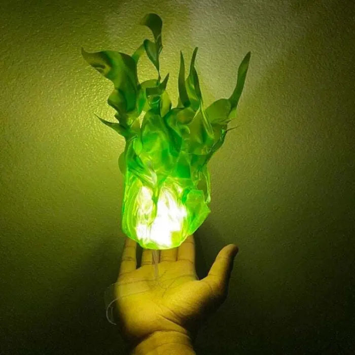 Handheld fireball prop glowing in vivid green with flame-like design, floating above a hand.