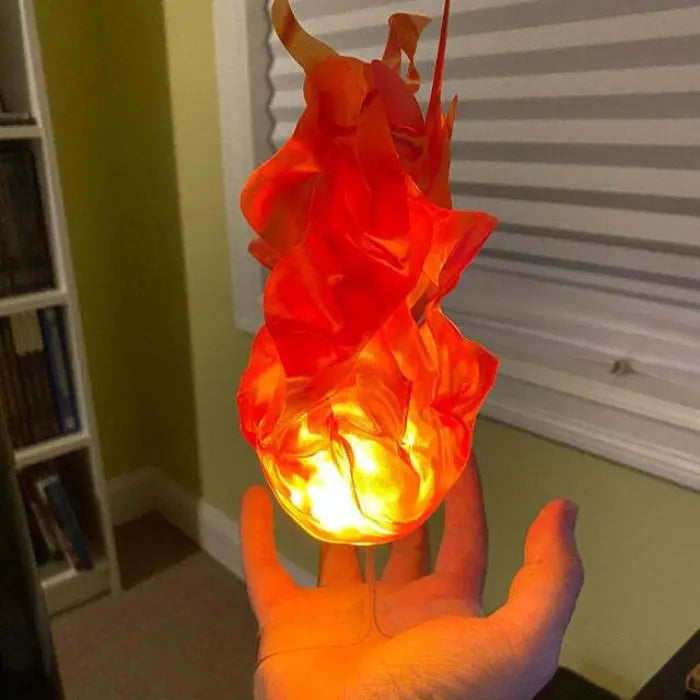 Handheld fireball prop emitting warm orange glow, flame-shaped design held in bedroom setting.