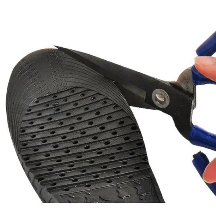 Height increasing insoles being trimmed along size marks with scissors for customized fit.