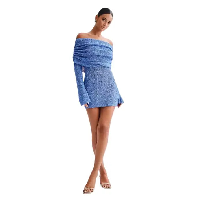 Knitted blue dress styled off-shoulder with long sleeves and mini fit on standing model.