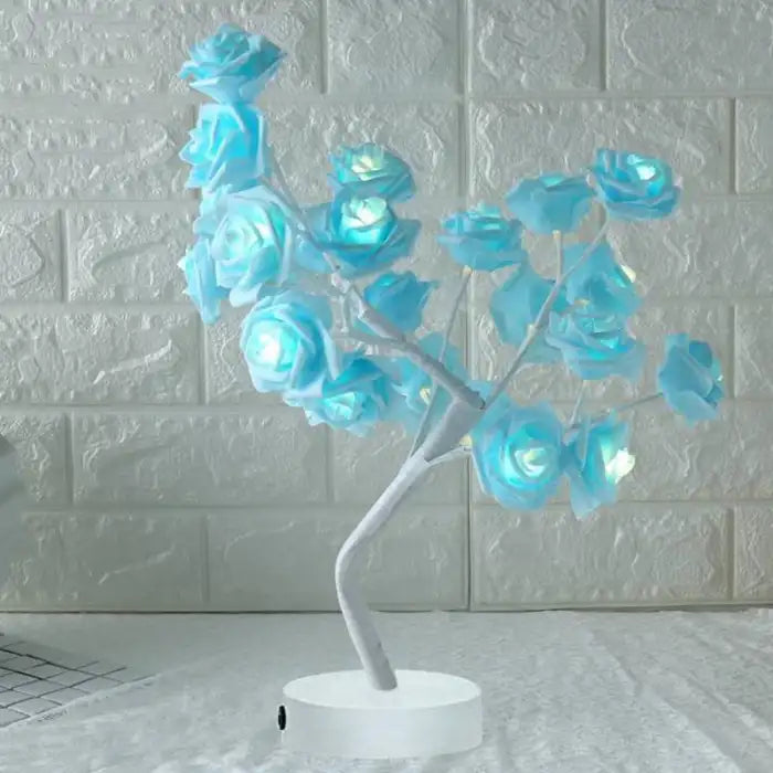 LED tree lamp with soft blue rose lights and white stem, placed in a modern decorative setup.