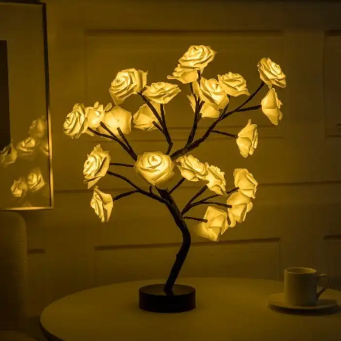 LED tree lamp with a soft yellow rose glow, enhancing cozy interior ambiance on a side table.