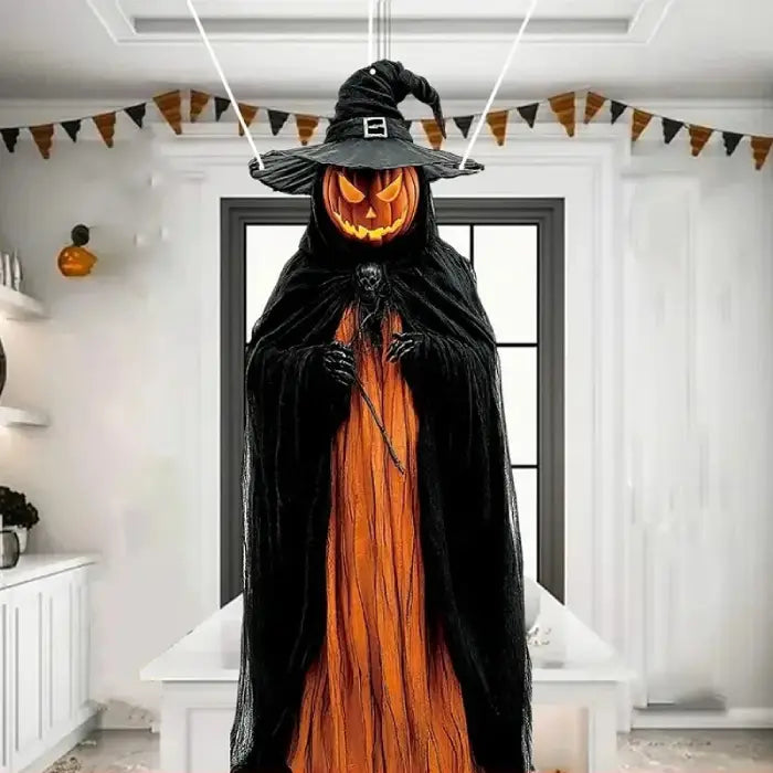 Life size Halloween prop with pumpkin head and wizard costume hanging in decorated indoor setting.