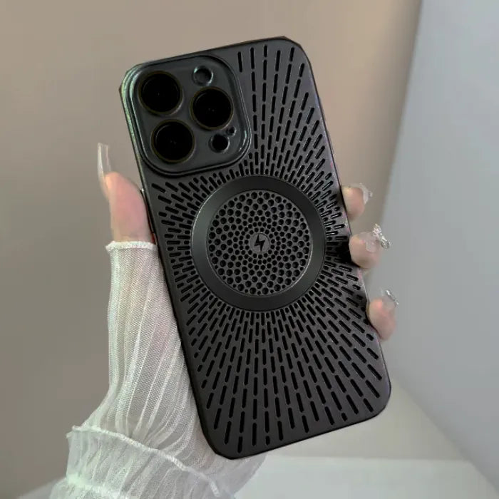 Magnetic wireless phone case in matte black with vented back pattern shown in hand under soft light.