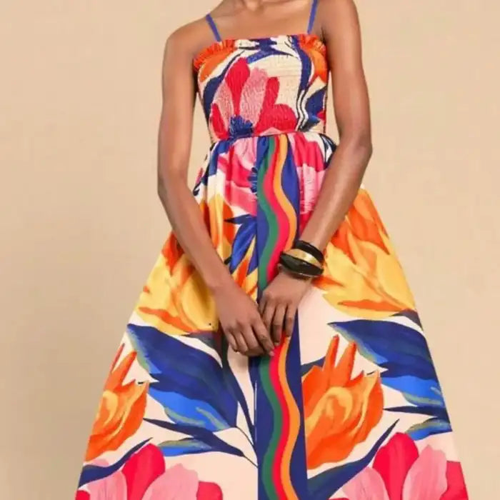 Maxi dress front close-up showing bold floral pattern and gathered bodice with thin shoulder straps.