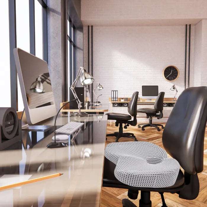 Professional office workspace featuring ergonomic seat cushion on office chair in modern setting
