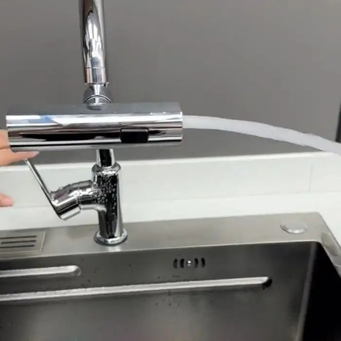 Multi use faucet spraying water forcefully to the side, demonstrating wide range and splash reach.