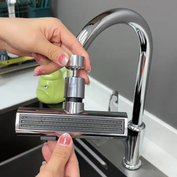 Multi use faucet being installed on chrome kitchen tap with quick-connect rotating adapter.