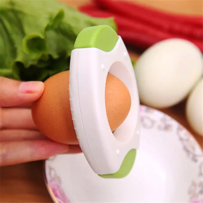 handheld kitchen egg opener positioned to crack a brown egg over a bowl