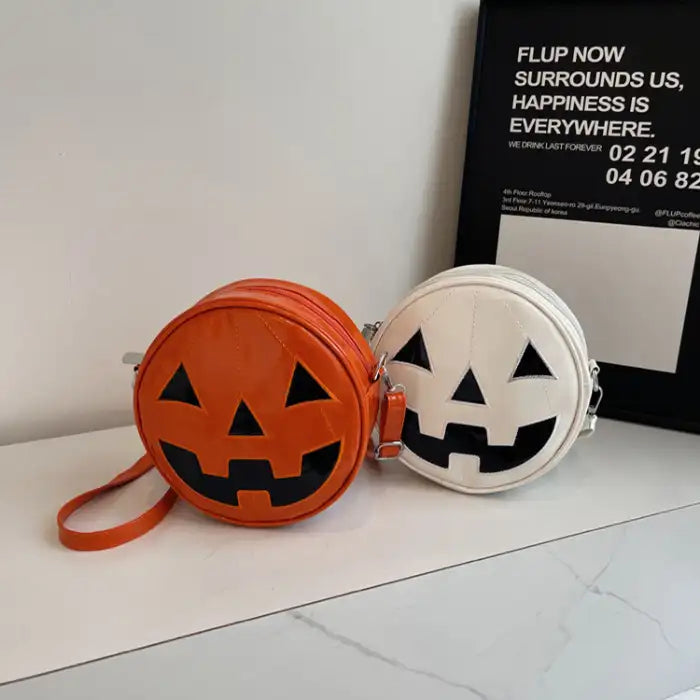 Pumpkin Head Purse in orange and white with jack-o-lantern face, displayed on a modern tabletop.