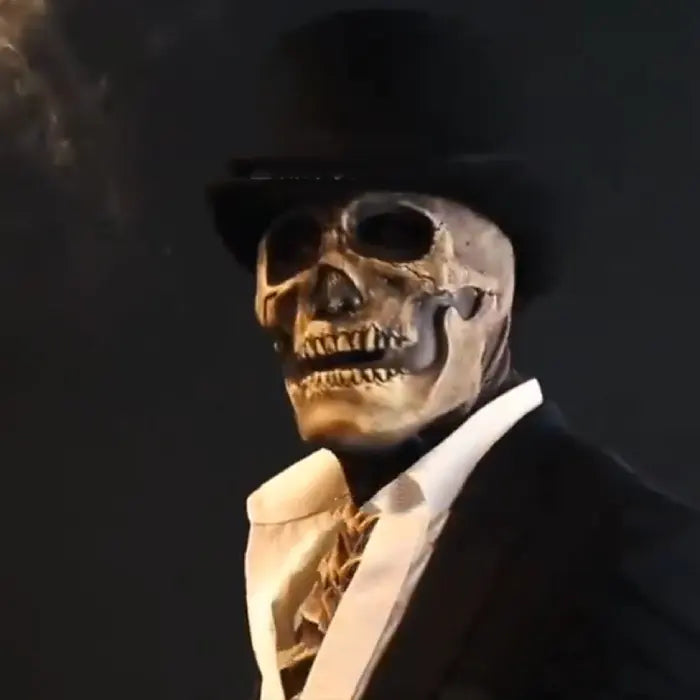Realistic Halloween skeleton mask worn with formal suit and top hat in a dramatic black setting.