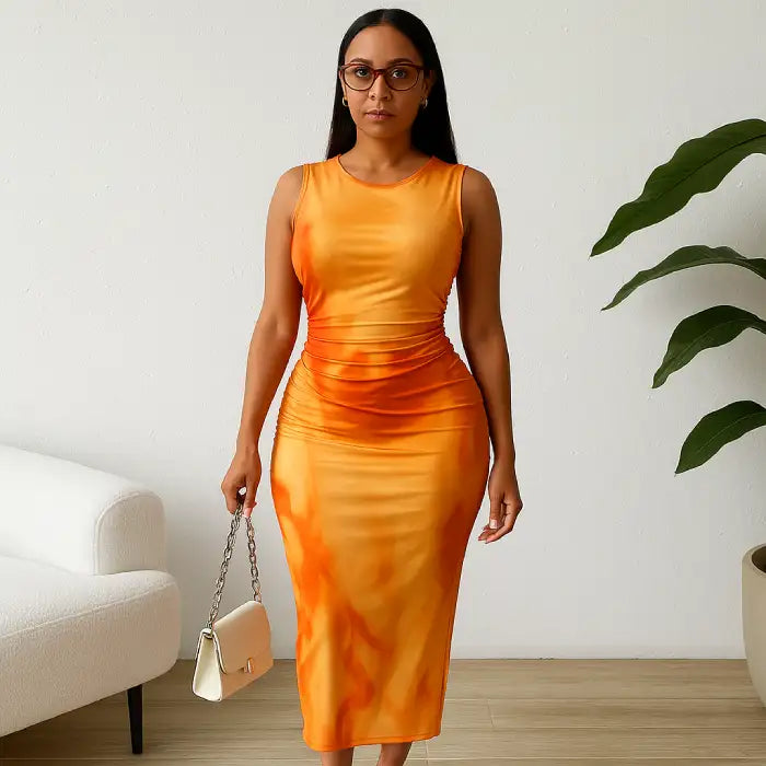 Orange ruched maxi form-fitting dress styled with a chain bag, featuring a sleeveless design and flattering fit.