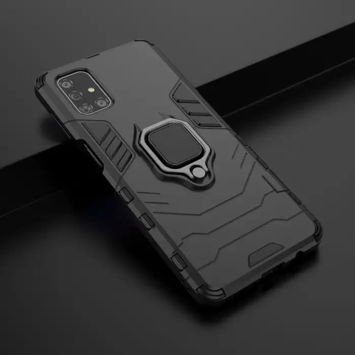 Black Samsung phone case with rugged design, built-in ring holder, and precise cutouts, shown on a phone with the screen facing forward.