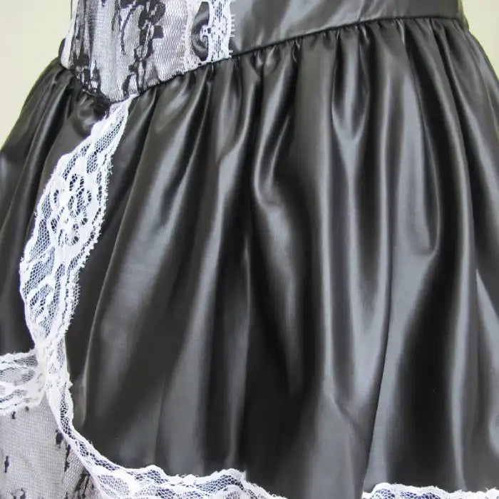 Sexy Maid Halloween Costume faux leather skirt close-up with white lace trim and black gloss finish.