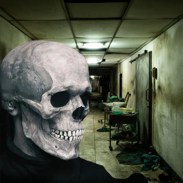 Skull mask facing sideways in dirty hospital corridor with medical carts and fluorescent lighting.