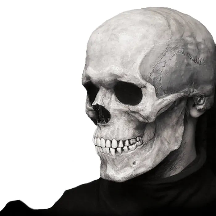 Skull mask with realistic bone detailing worn with black turtleneck, isolated on white background.