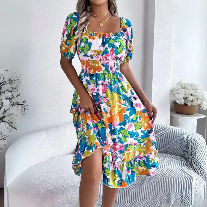 Smocked off shoulder floral midi dress front view in green orange floral with puff sleeves.