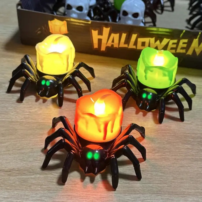 Spider candle trio with glowing LED lights displayed in Halloween-themed retail box.