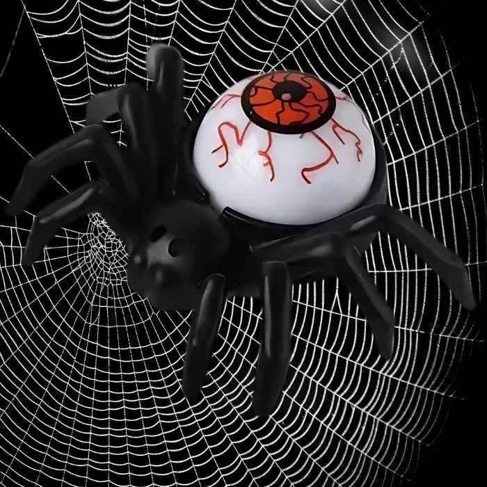 Spider candle with orange eyeball body placed against dark Halloween web background.
