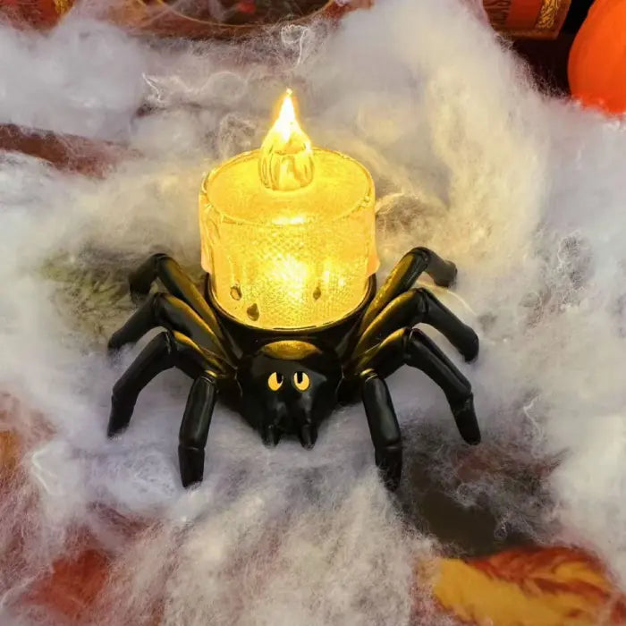 Spider candle with textured yellow LED light in Halloween cobweb setup.