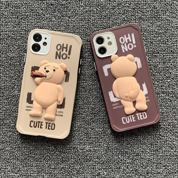 Duo of Ted iPhone case protectors in beige and brown with 3D teddy bear designs and playful "OH! NO!" text.
