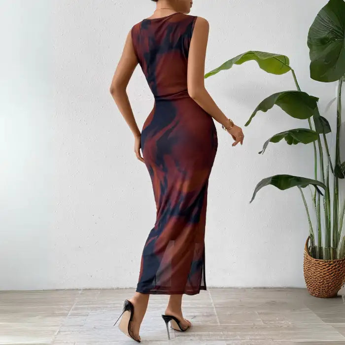 Pink tie dye maxi dress with a sleeveless, form-fitting design and a side slit for a chic look.