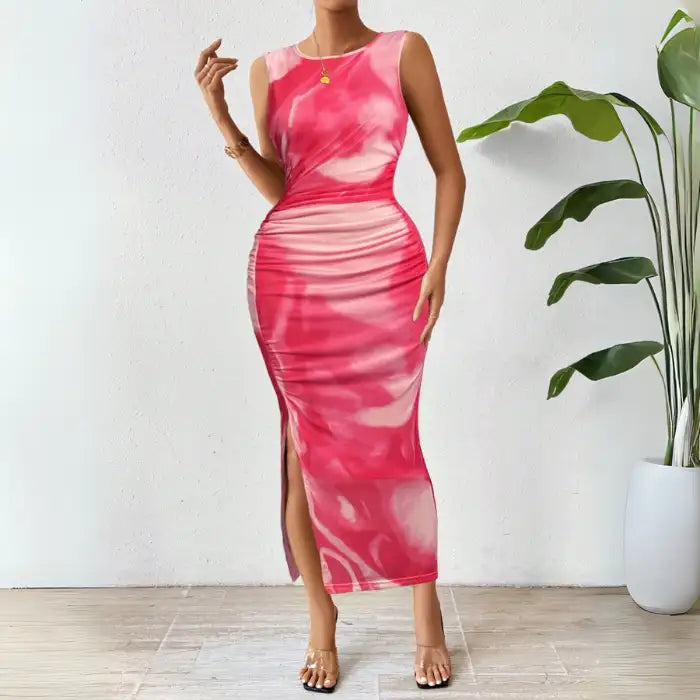 Pink tie dye maxi dress with a sleeveless, form-fitting design and a side slit for a chic look.