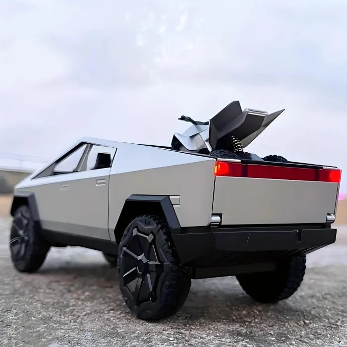 Toy vehicle set showing silver pickup truck carrying mini quad bike in rear cargo bed on outdoor surface.